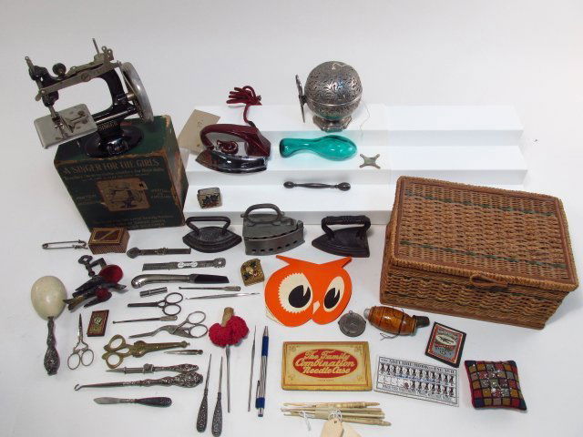 VINTAGE SINGER SEWING MACHINE & SEWING ACCESSORIES: Lot including a vintage miniature portable child's sewing machine, and a large number of various sewing accessories: thimbles, sterling handled accessories, sock darners, advertising, pin cushions, mi