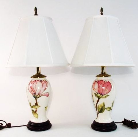 PAIR MOORCROFT "MAGNOLIA" POTTERY TABLE LAMPS: Pair of Moorcroft glazed pottery table lamps in the "Magnolia" pattern. Each measures a total of 27" tall to tip of finial. Pottery portion vase itself measures 10" tall. Each lamp is signed on the si