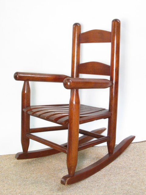 WOODEN CHILDS ROCKING CHAIR: Wooden Childs Rocking Chair. Measures as follows: Height 23 1/4", Wall depth 19 1/2", Length 14.5". Condition: Good, normal wear to finish, See pictures. Shipping Weight: Approx. 5lbs.