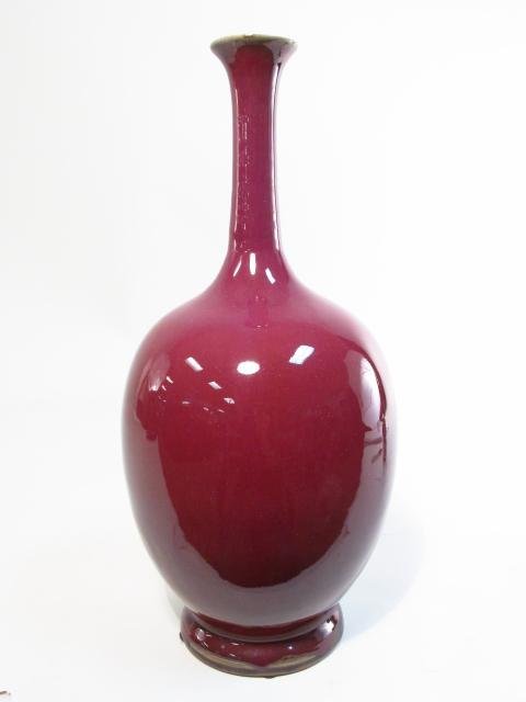 CHINESE SANG DE BOEUF STYLE GLAZED BOTTLE VASE: Chinese sang de boeuf style glazed pottery bottle vase measuring 17.75" tall x 7.75" wide. Unmarked. Condition: good, see images. Weight: 10 lbs.