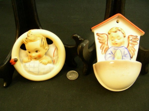 HUMMEL HOLY WATER FONT ANGLE & CHILDS PLAQUE: Lot 750: HUMMEL HOLY WATER FONT ANGLE & CHILDS PLAQUE - Child's Bed Wall Plaque HUM 137 measures 3" wide. Holy Water Font White Angle HUM 75 measures 4 1/2" high by 3" wide. Stylized Bee mark on both.