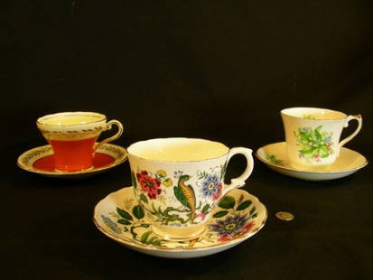 ROYAL ASCOT STAFFORDSHIRE AYNSLEY CUPS SAUCERS 3 SETS: Lot 1101: ROYAL ASCOT STAFFORDSHIRE AYNSLEY CUPS SAUCERS 3 SETS - Royal Ascot floral with gilt trim measures 3" high x 4" wide and saucer is 5 1/2" wide, Staffordshire is floral and birds, cup at 3"