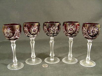 FIVE SML RUBY CUT TO CLEAR CRYSTAL STEM GLASSES: Lot 1108: FIVE SML RUBY CUT TO CLEAR CRYSTAL STEM GLASSES - Measures 5" high by 2" wide. No chips or cracks except for a flea bite on the base rim of one glass.