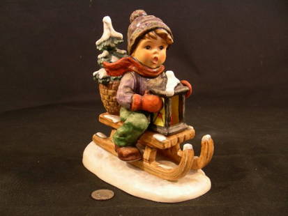 HUMMEL PORCELAIN FIGURE RIDE INTO CHRISTMAS TM5: Lot 1111: HUMMEL PORCELAIN FIGURE RIDE INTO CHRISTMAS TM5 - measures 6" tall by 5" wide. condition very good but for small crazing.