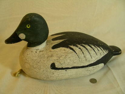 EARLY 20TH C GOLDEN EYE WOOD WORKING DUCK DECOY: Lot 1113: EARLY 20TH C GOLDEN EYE WOOD WORKING DUCK DECOY - Probably circa 1920 - 1930 solid wood carved decoy rigged for hunting. Decoy measures 12 1/2" long by 6 1/4" wide and 6 1/2" tall.