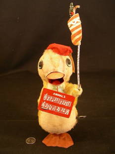 VINTAGE WORKING WIND UP BABY DUCK TOY MADE IN JAPAN: Lot 1115: VINTAGE WORKING WIND UP BABY DUCK TOY MADE IN JAPAN - Duck is holding a music sheet in one hand and a banner with a christmas in the other hand. When wound up ducks mouth opens and closes