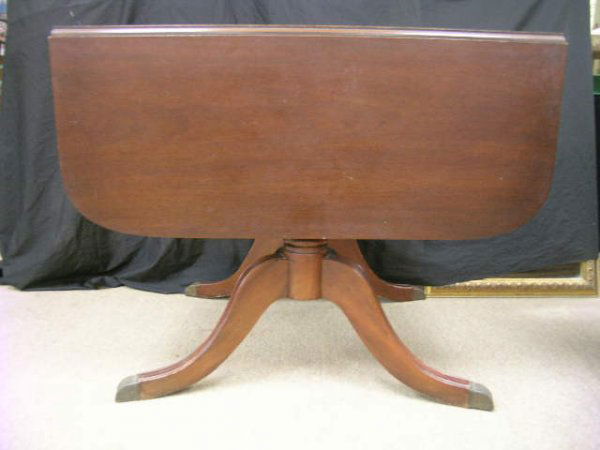 DREXEL DUNCAN PHYFE STYLE DROP LEAF DINING TABLE: Lot 1172: DREXEL DUNCAN PHYFE STYLE DROP LEAF DINING TABLE - Measures 30" high x 38" wide x 21" deep. One leaf measuring 15 1/4" deep. Table opens to 52 1/2". Scratches and blemishes to finish.