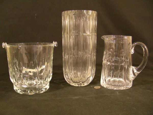 STUART CRYSTAL BAR PITCHER ICE BUCKET VASE 3 PCS: Lot 697: STUART CRYSTAL BAR PITCHER ICE BUCKET VASE 3 PCS - Vase is 8" high x 3 1/2" wide, pitcher is 5 1/2" high x 5 1/2" wide and ice bucket is 5" high x 5" wide. No chips or cracks.