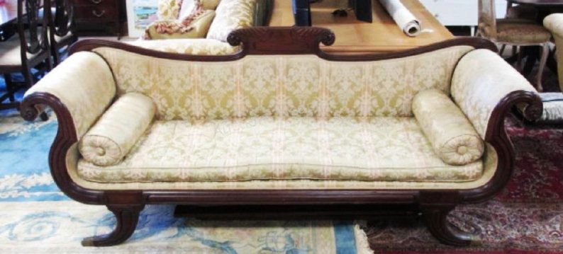 DUNCAN PHYFE STYLE EMPIRE SOFA: Duncan Phyfe style empire sofa measuring a total of 85" wide x 35" tall and 25" deep. Rolled arms and brass feet. Condition: minor signs of discoloration to upholstery, minor splits to wood holding ba