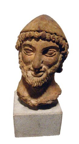 19th Century limestone head of a bearded male: Nice limestone head of a bearded male, 19th Century. H: 4 7/8" (12.4 cm). Mounted on a base.