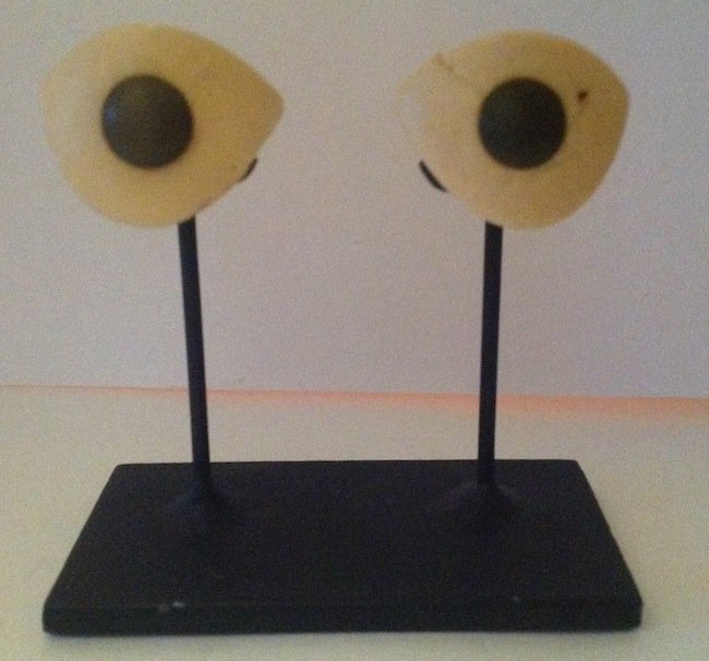 Syria, 2 of white marble eye insets for statue: A pair of white marble eye insets for a statue, Syria, c. 1st Millennium BC, the irises indicated with black serpentine. Both are intact and quite unusual with drilled holes running through the back, 