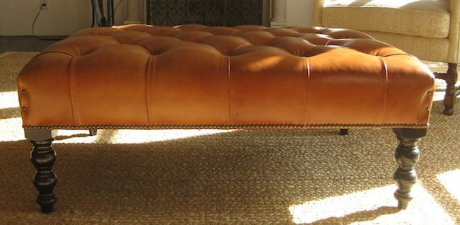 George Smith Leather Covered Ottoman: The four turned ebonised wood legs supporting the rectangular form leather tufted covered cushion, manufacturer George Smith, 1980's; 16 x 41 x 30"