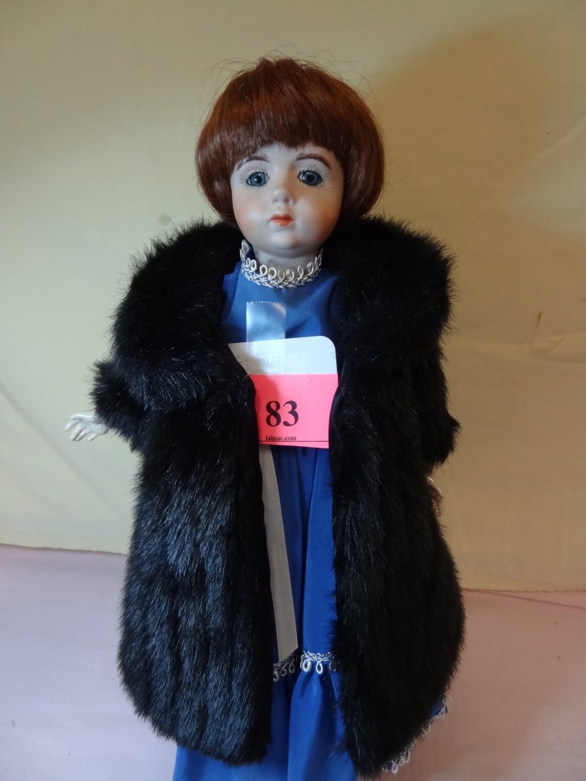 16'' BISQUE HEAD, COMPOSITION BODY AND LIMBS. BROWN: 16'' BISQUE HEAD, COMPOSITION BODY AND LIMBS. BROWN HAIR, BLUE GLASS EYES. DRESSED IN AN EVENING GOWN AND FAUX FUR COAT. ARTIST SIGNED '1986 BETTY'