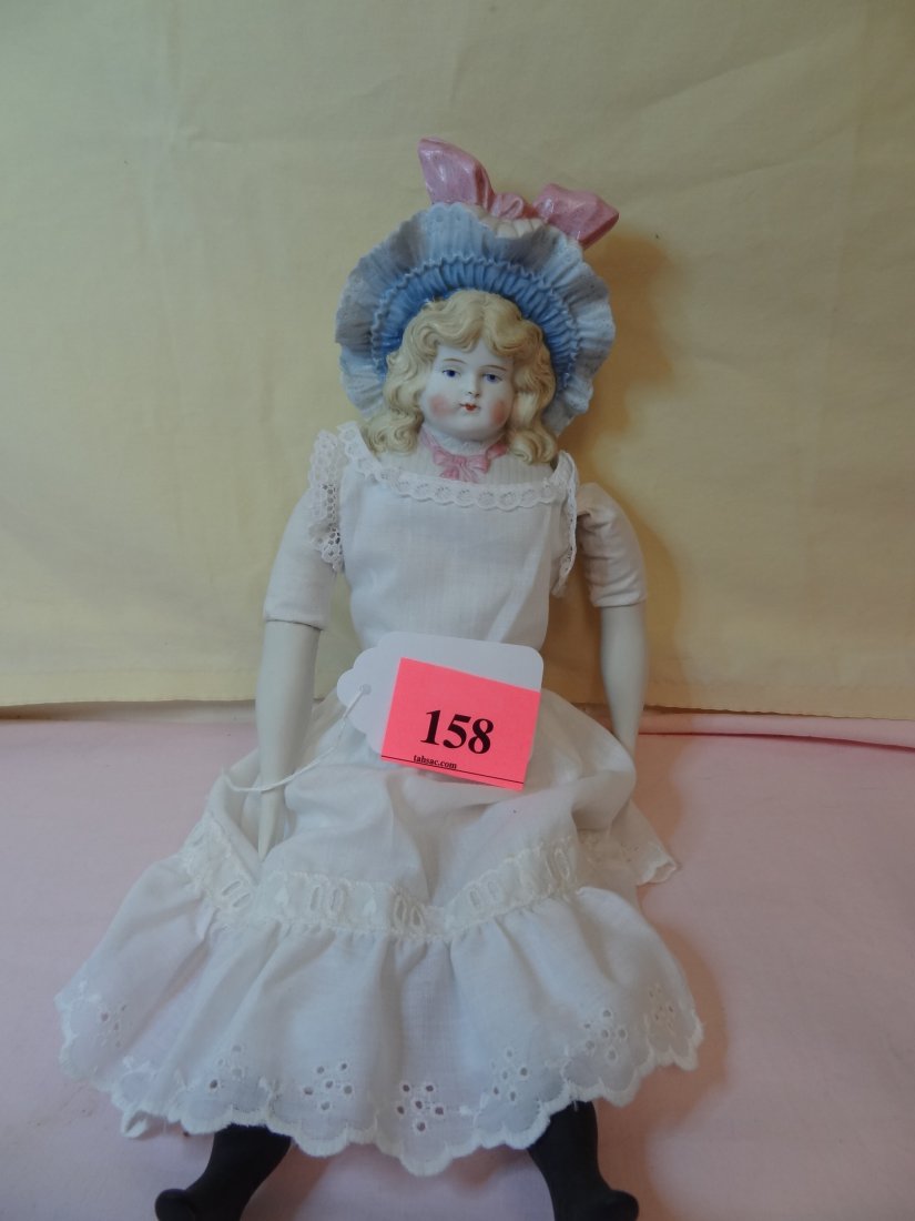 BOW TO FEET 15'' BISQUE MOLDED HEAD, ARMS AND LEGS: BOW TO FEET 15'' BISQUE MOLDED HEAD, ARMS AND LEGS, MOLDED HAT AND TIE, BLACK PAINTED BOOTS BLOND PAINTED HAIR AND BLUE PAINTED EYES, CLOTH BODY, PRETTY FACE, MARKED ''2''