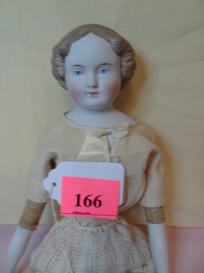 20'' BISQUE MOLDED HEAD AND LIMBS, HARD CLOTH BODY: 20'' BISQUE MOLDED HEAD AND LIMBS, HARD CLOTH BODY, LIGHT BROWN/DARK BLONDE PAINTED HAIR, PAINTED BLUE EYES, PAINTED BLACK BOOTS WITH SOCKS, NO VISABLE MARKS