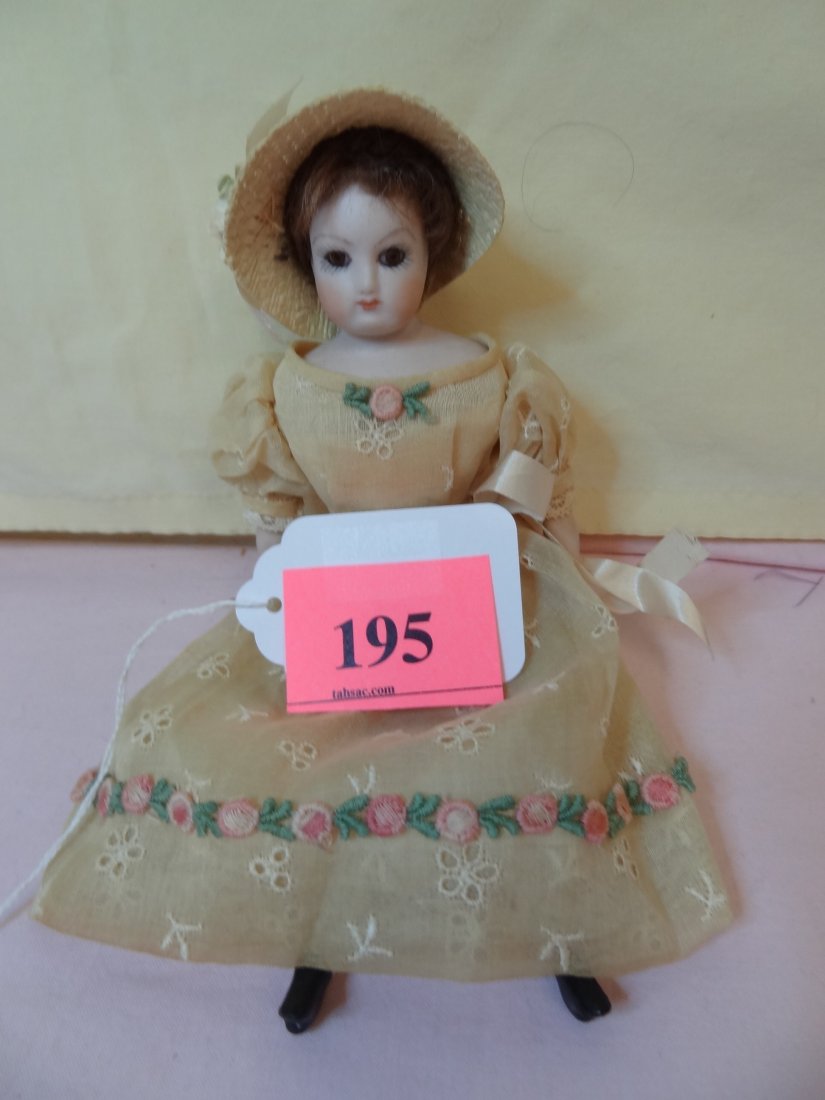 8.5'' BISQUE HEAD AND LIMBS, CLOTH BODY, BROWN HAI: 8.5'' BISQUE HEAD AND LIMBS, CLOTH BODY, BROWN HAIR, BROWN GLASS EYES, PAINTED BLACK BOOTS, CUTE SPRING TIME OUTFIT WITH MATCHING HAT,MARKED ZAWADZKA 1968''