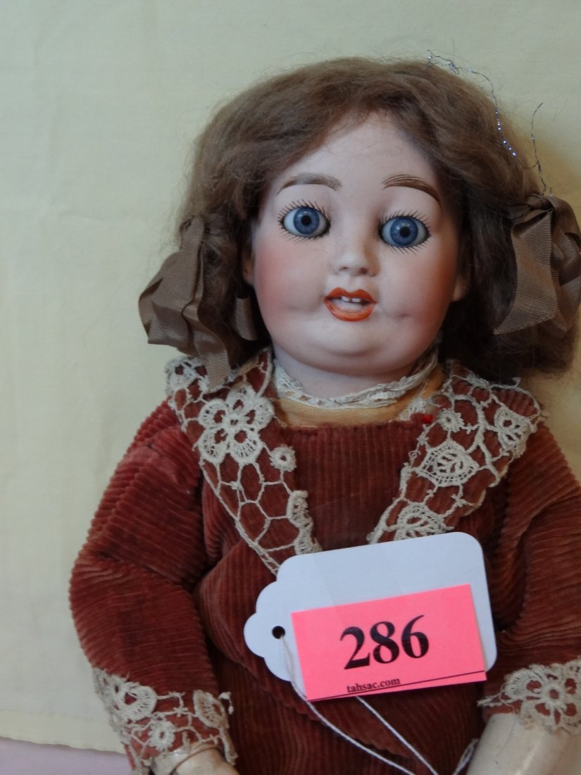 19'' BISQUE HEAD, COMPOSITION BODY, MOVABLE LIMBS : 19'' BISQUE HEAD, COMPOSITION BODY, MOVABLE LIMBS AND JOINTS, BLUE GLASS SLEEY EYES, OPEN MOUTH WITH TEETH, BROWN HAIR WITH BOWS, SOME BODY WEAR, MARKED '' DEPOSE TOTO M4MIAFONO SC ALEX LIMOGES''