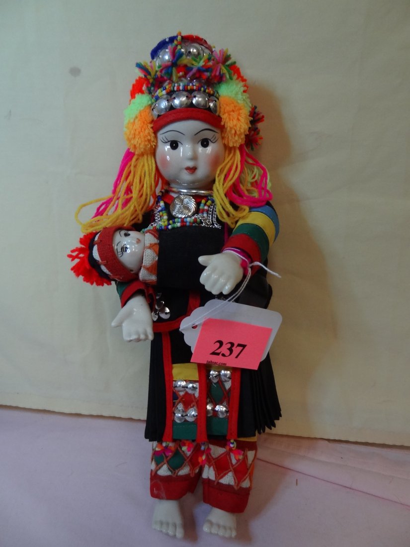 14'' DESIGNED BY VANIDA S. MONGKHON HANDMADE BY YO: 14'' DESIGNED BY VANIDA S. MONGKHON HANDMADE BY YOUTHANA MADE IN THAILAND HEAD, HANDS AND FEET MADE FROM CHINA, CLOTH BODY, THAILAND COSTUME WITH DETAILED DESIGN HOLDING BABY IN BLANKET, BLACK PAINTED