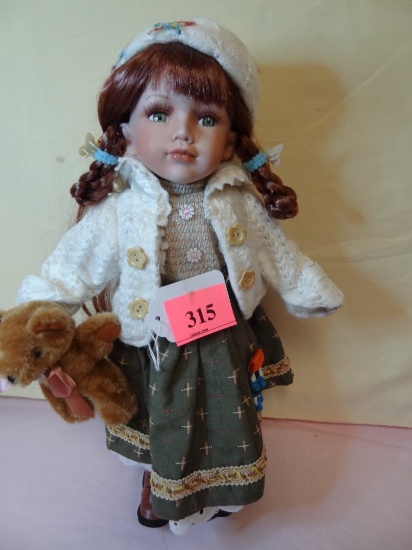 16''BISQUE HEAD AND LIMBS, CLOTH BODY, RED BRAIDED: 16''BISQUE HEAD AND LIMBS, CLOTH BODY, RED BRAIDED HAIR, GREEN GLASS EYES, ADORABLE SCHOOL OUTFIT WITH MATCHING JACKET AND HAT, HOLDING A LITTLE BEAR, MARKED ''CATHAY COLLECTION 635/5000''
