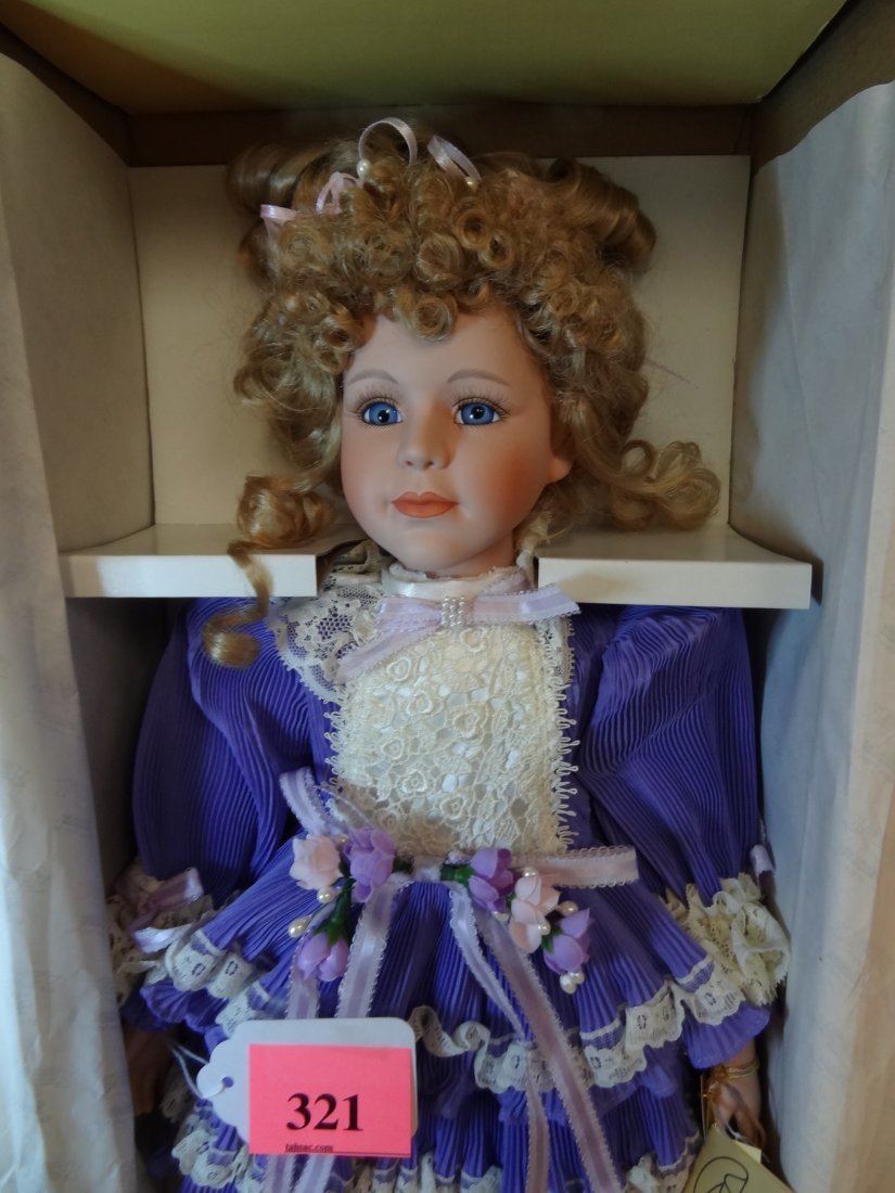 22'' MANN LIMITED EDITION WITH COA NEW IN BOX, BIS: 22'' MANN LIMITED EDITION WITH COA NEW IN BOX, BISQUE HEAD AND LIMBS, SOFT CLOTH BODY, BLONDE HAIR, BLUE GLASS EYES, TAG STILL ATTACHED, BEAUTIFUL PURPLE DRESS