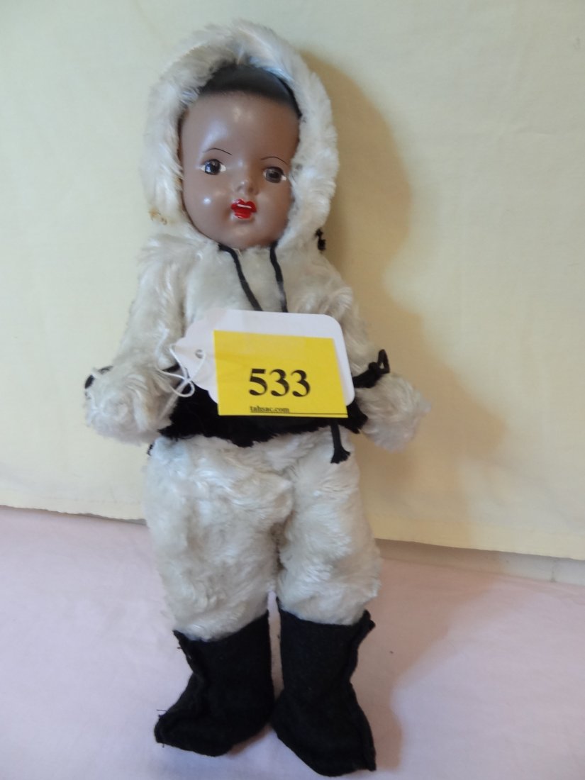 13'' COMPOSITION HEAD AND BODY, MOVEABLE ARMS AND : 13'' COMPOSITION HEAD AND BODY, MOVEABLE ARMS AND LEGS, PAINTED BLACK HAIR, BROWN EYES, WHITE WINTER JUMP SUIT WITH BLACK FUR TRIM, NO VISIBLE MARKS