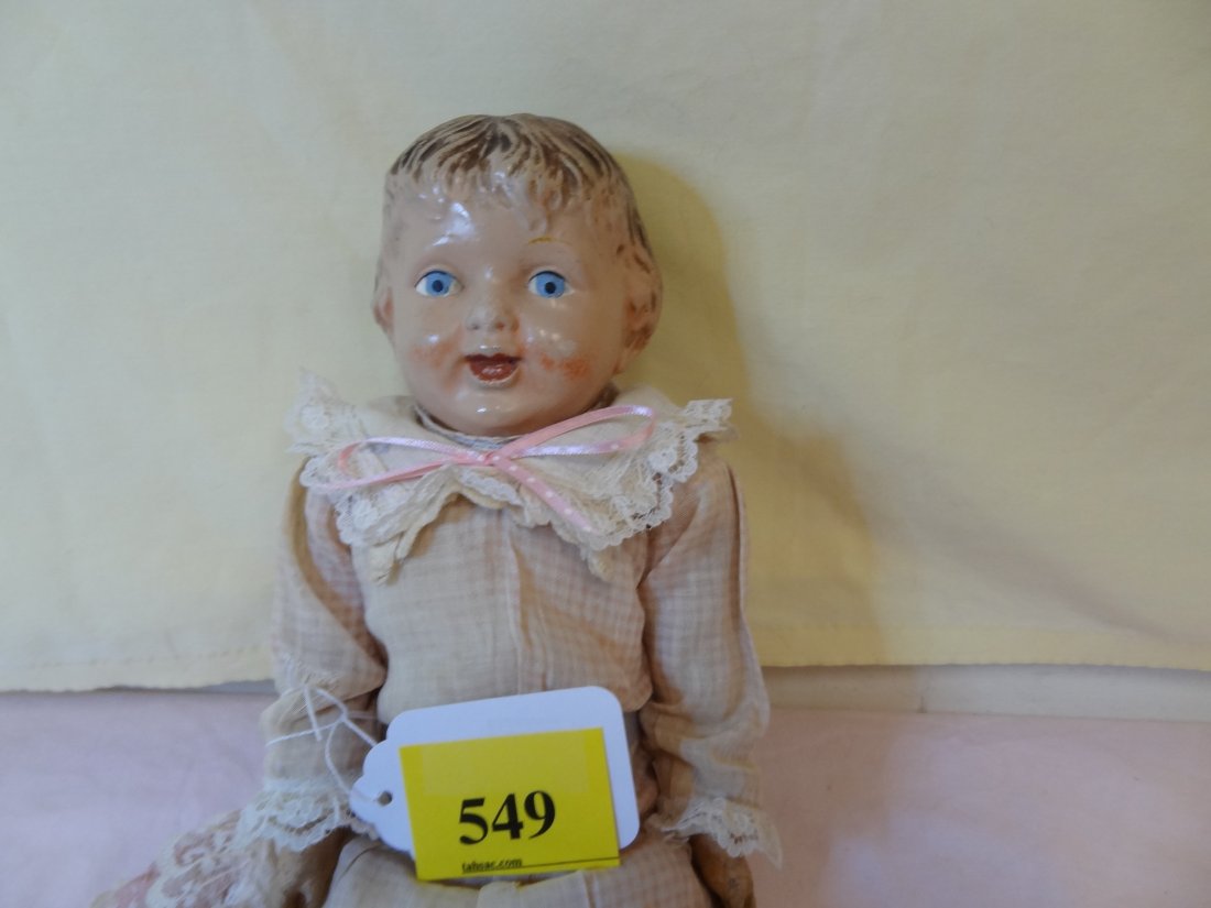 14'' COMPOSITION HEAD, HANDS AND FEET, CLOTHE SOFT: 14'' COMPOSITION HEAD, HANDS AND FEET, CLOTHE SOFT BODY, BROWN PAINTED HAIR, BLUE PAINTED EYES, OPEN MOUTH SMILE, PINK CHECK DRESS WITH LACE, PAINTED BROWN BOOTS, WEAR ON HANDS AND NOSE, MARKED ''M.T.