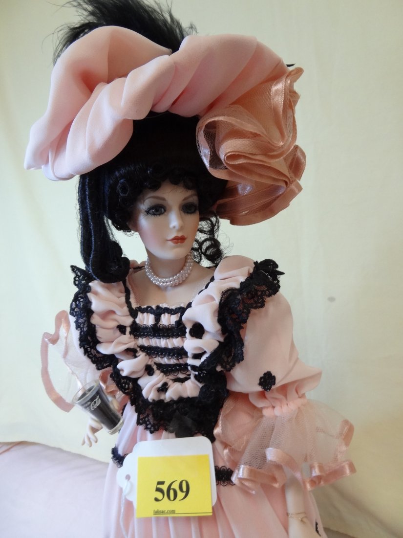 21'' COCA-COLA DOLL, BISQUE HEAD, HANDS AND LEGS, : 21'' COCA-COLA DOLL, BISQUE HEAD, HANDS AND LEGS, FANCY PINK AND BLACK DRESS WITH MATCHING HAT, BLACK HAIR WITH BLUE GLASS EYES WITH GLASS OF COCA-COLA IN HAND, BY FRANKLIN HEIRLOOM DOLLS