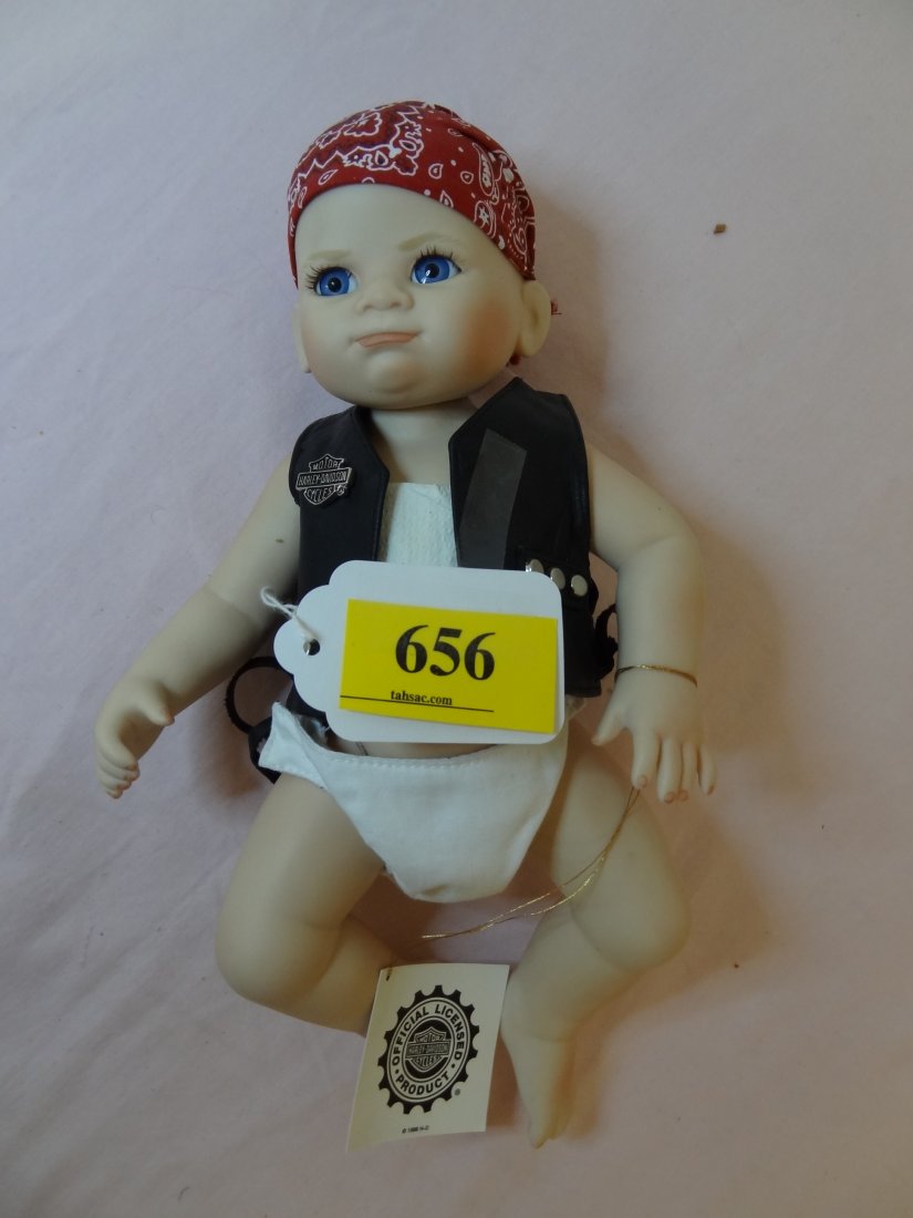 12'' 'FHD' "HARLEY-DAVIDSON FRANKLIN HEIRLOOM: 12" MARKED 'FHD' - 'HARLEY-DAVIDSON FRANKLIN HEIRLOOM DOLL", WITH LEATHER VEST AND HEADBAND, BLUE GLASS EYES, BLONDE PAINTED, TAG ATTACHED, PAINTED TOENAILS AND FINGERS,