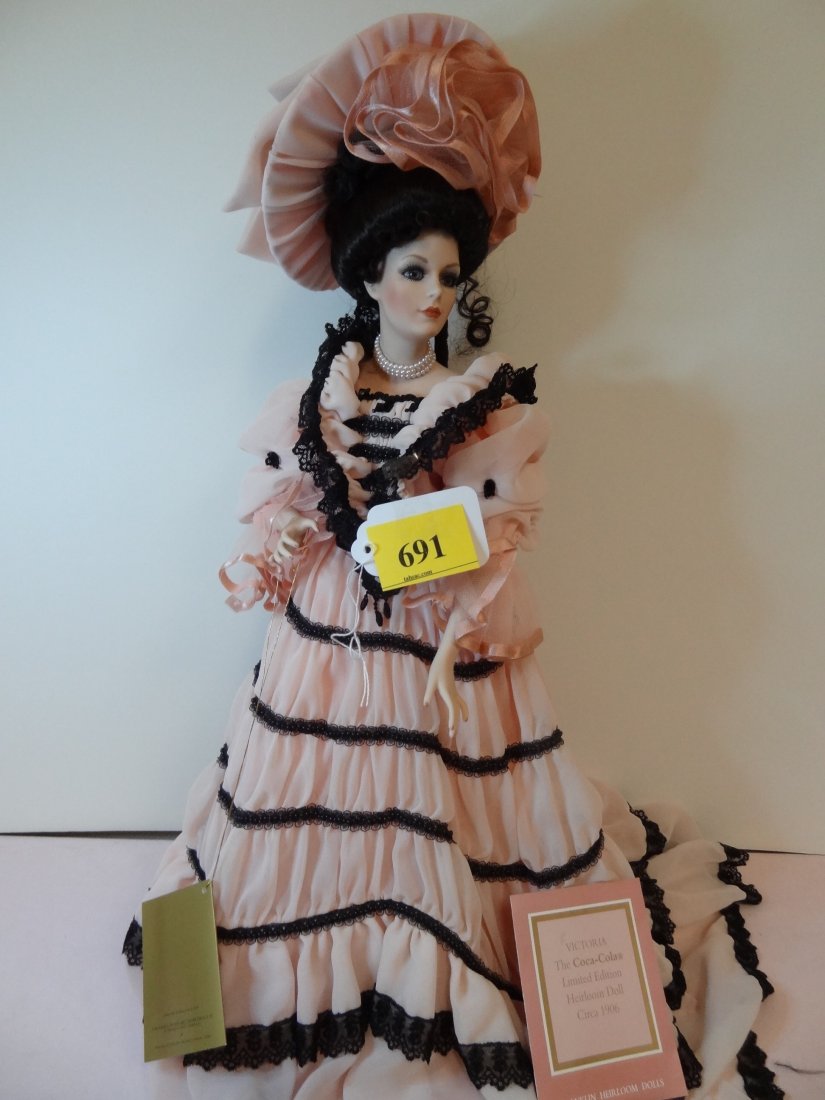 21'' COCA-COLA DOLL, BISQUE HEAD, HANDS AND LEGS, : 21'' COCA-COLA DOLL, BISQUE HEAD, HANDS AND LEGS, FANCY PINK AND BLACK DRESS WITH MATCHING HAT, BLACK HAIR WITH BLUE GLASS EYES WITH GLASS OF COCA-COLA IN HAND, BY FRANKLIN HEIRLOOM DOLLS