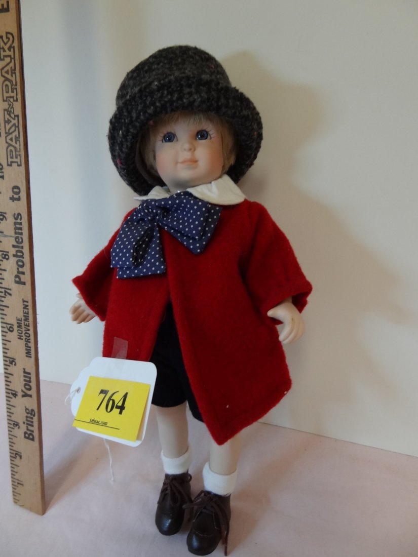 13'' TALL, MARKED: 0360/2000, SKIPPY, ALL BISQUE D: 13'' TALL, MARKED: 0360/2000, SKIPPY, ALL BISQUE DOLL WITH MOVEABLE JOINTS, BLONDE HAIR, BLUE GLASS EYES, WEARING A LARGE WOOL HAT, RED FELT JACKET WITH WHITE COLLAR AND BLUE AND WHITE POLKA DOT BOW, 