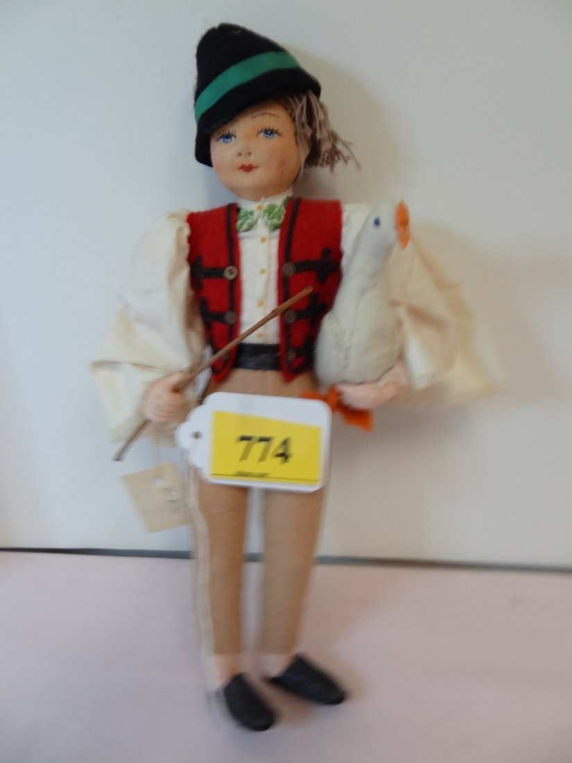 O12'' LENCI TYPE, FELT DOLL, PAPER TAG: T1179, 902: O12'' LENCI TYPE, FELT DOLL, PAPER TAG: T1179, 9021, 157, HUNGARY, DRESSED IN HUNGARIAN GARB, CLOTHE DOLL WITH BABY BLUE SKY EYES WITH RED LIPS, CARRYING FELT GOOSE.