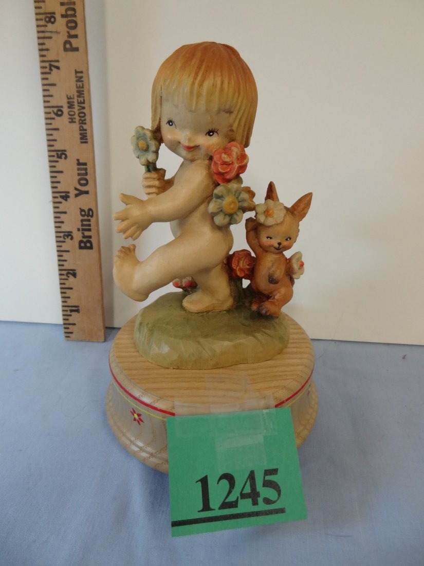 ANRI ITALY MUSICAL WOODCARVED FIGURINE. 7'' TALL, SWEET: ANRI ITALY MUSICAL WOODCARVED FIGURINE. 7'' TALL, SWEET NUDE LITTLE GIRL WITH BUNNY AND FLOWERS. SIGNED FERNANDEZ ON BACK OF SCENE.