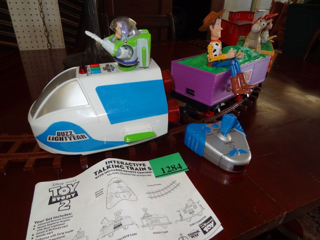 DISNEY - PIXAR TOY STORY II LARGE SCALE USED TRAIN SET.: DISNEY - PIXAR TOY STORY II LARGE SCALE USED TRAIN SET. ITEM #63029. BUZZ LIGHTYEAR, WOODY, JESSIE AND BULLSEYE CART, PLUS ZURG CABOOSE WITH 12 PIECE INTERLOCKING TRACK AND REMOTE CONTROL. NEEDS BATTE