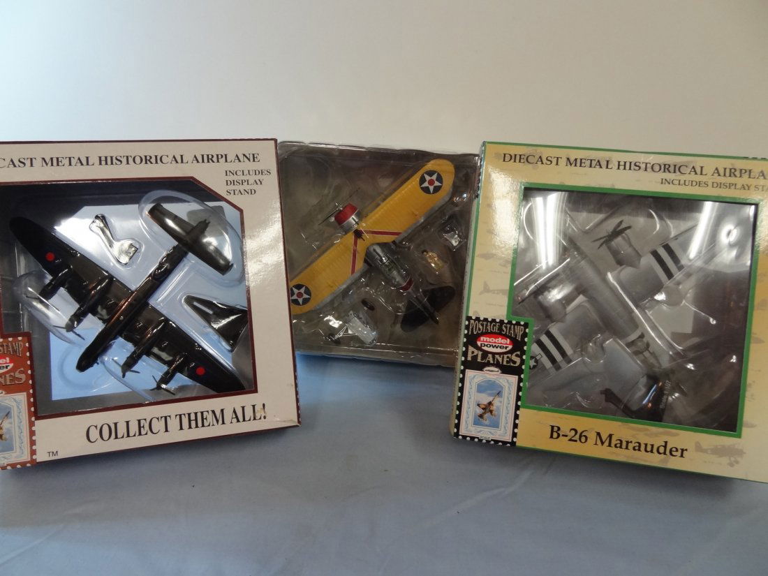 THREE DIECAST METAL HISTORICAL AIRPLANES; TWO POSTAGE S: THREE DIECAST METAL HISTORICAL AIRPLANES; TWO POSTAGE STAMP MODEL POWER PLANES, B-26 MARAUDER ''BABY BUMPS II'' AND AVRO LANCASTER INCLUDES DISPLAY STAND; GRUMMAN F3F AIRPLANE. ALL NEW IN BOX.