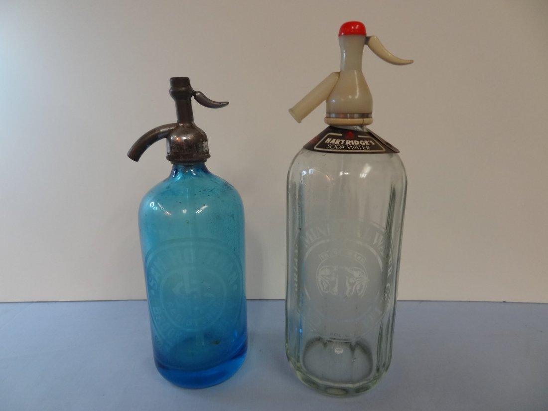 TWO VINTAGE SELTZER BOTTLES; A CLEAR CAMBRIAN MINERAL W: TWO VINTAGE SELTZER BOTTLES; A CLEAR CAMBRIAN MINERAL WATER CO. 13'' TALL AND A BLUE SAM HOFFMAN BROOKLYN N.Y. 11'' TALL.