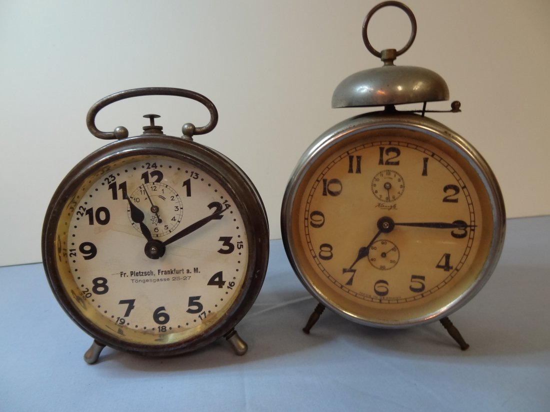 MADE IN GERMANY ALARM CLOCKS - LOT OF TWO GERMAN CLOCKS: MADE IN GERMANY ALARM CLOCKS - LOT OF TWO GERMAN CLOCKS. FR. PLETZSCH, FRANKFURT a.M. 5'' TALL, IT WORKS. KIENZLE ALARM CLOCK IS 6'' TALL. DOESN'T WORK; BOTH CLOCKS NEED CLEANING AND ADJUSTMENTS. THE 