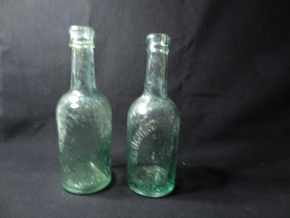 VINTAGE LIGHT GREEN BOTTLES. 1) MANCHESTER BREWING COMP: VINTAGE LIGHT GREEN BOTTLES. 1) MANCHESTER BREWING COMPANY, BOTTLE MAKER; NUTTAL & CO 1873-1916, BOTTOM EMBOSSED 'NNCO' 7 7/8 IN BY 2 1/2IN 2) TAYLOR'S EAGLE BREWERY LIMITED / MANCHESTER BOTTOM EMBOSS