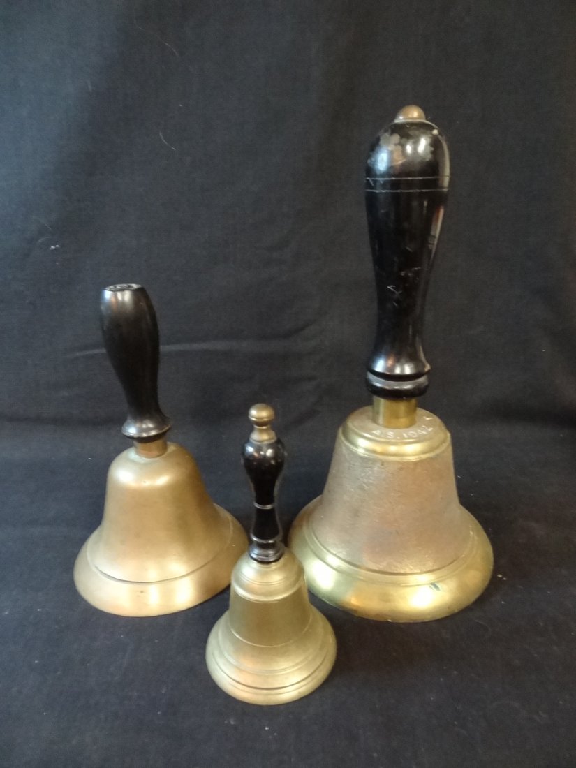 THREE BRASS SCHOOL BELLS; 10'' BELL MARKED A.S. 1942, 7: THREE BRASS SCHOOL BELLS; 10'' BELL MARKED A.S. 1942, 7'' BELL HAS BRASS FINIAL MISSING, AND 5.5'' BELL. ALL IN GOOD CONDITION.