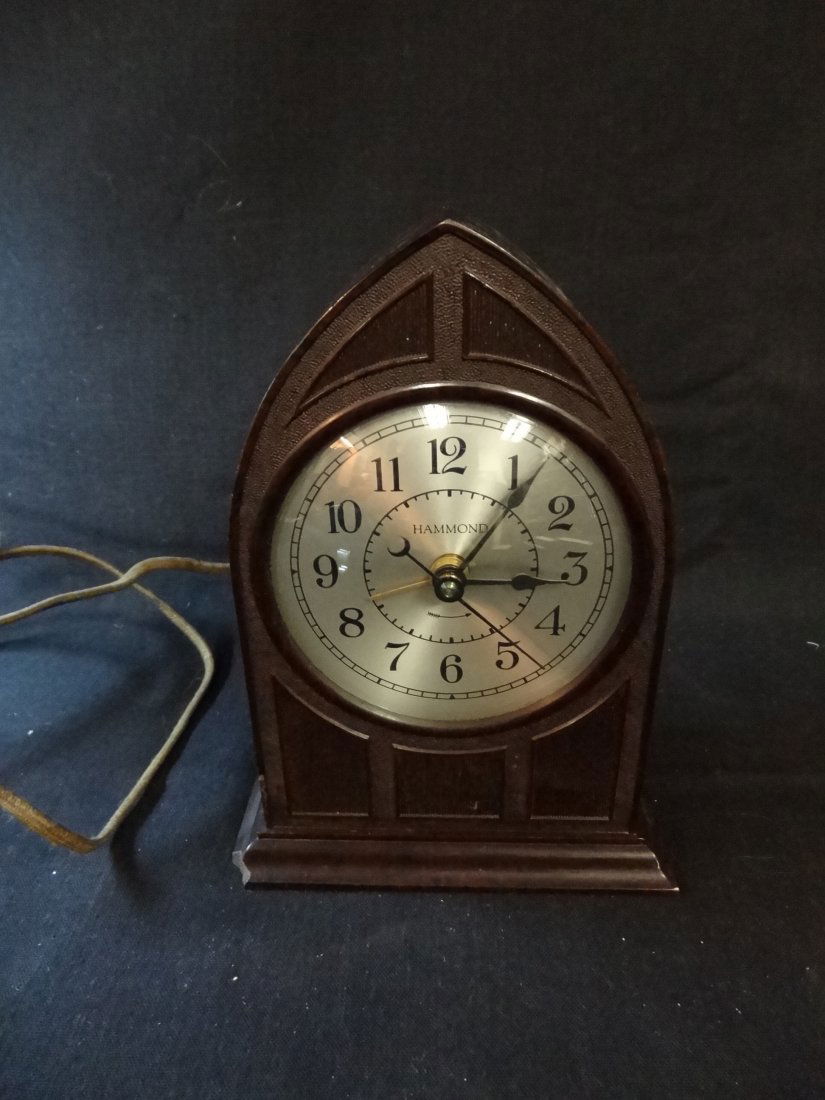 VINTAGE HAMMOND ELECTRIC ALARM CLOCK IN DOME SHAPE CELL: VINTAGE HAMMOND ELECTRIC ALARM CLOCK IN DOME SHAPE CELLULOID CASE, HAS ORIGINAL WIRING, MARKED THE HAMMOND CLOCK CO., CHICAGO, IL. 7'' TALL, IN GOOD CONDITION EXCEPT FOR SMALL CHIP OF FRONT CORNER.