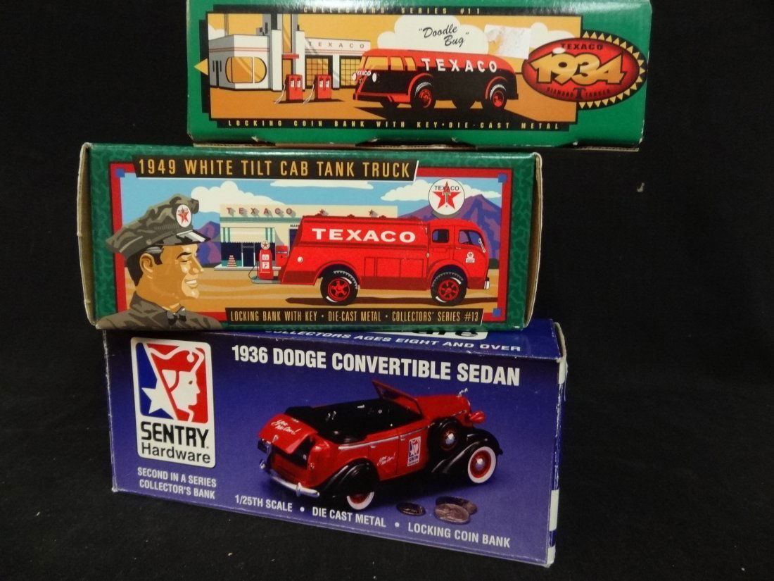 THREE COLLECTOR'S COIN BANKS: 1) 1936 DODGE CONVERTIBLE: THREE COLLECTOR'S COIN BANKS: 1) 1936 DODGE CONVERTIBLE SEDAN, 1/25TH SCALE, NEW IN BOX. 2) 1949 WHITE TILT CAB TANK TEXACO TRUCK, NEW IN BOX. 3) 1934 DIAMOND T TANKER TEXACO TRUCK, NEW IN BOX.