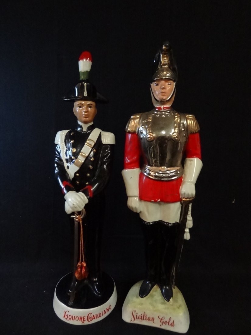 TWO VINTAGE DECANTERS: 1) LIQUORE GALLIANO, MARKED CORO: TWO VINTAGE DECANTERS: 1) LIQUORE GALLIANO, MARKED CORONETTI CUMAROO ITALY, 19'' TALL. 2) SICILIAN GOLD SOLDIER GUARD, 19'', MISSING THE FINIAL AND IN FAIR CONDITION.