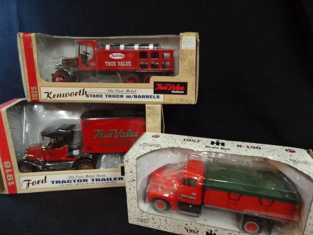 THREE DIE-CAST METAL TRUCKS; TRUE VALUE KENWORTH STAKE : THREE DIE-CAST METAL TRUCKS; TRUE VALUE KENWORTH STAKE TRUCK W/BARRELS, 8.5'' LONG, TRUE VALUE FORD TRACTOR TRAILER, 1/25 SCALE, 9'' LONG; FIRST GEAR COUNTRY GENERAL TRUCK, 8'' LONG, ALL NEW IN BOX.