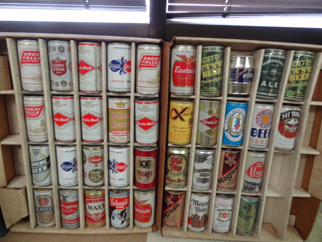 VINTAGE EMPTY BEER CAN COLLECTION IN CARDBOARD CARRYING: VINTAGE EMPTY BEER CAN COLLECTION IN CARDBOARD CARRYING CASE WITH 48 COMPARTMENTS, 10 ARE EMPTY. CLOSED POSITION MEASURES 17 X 21.5''. CARRYING CASE IS IN POOR CONDITION.
