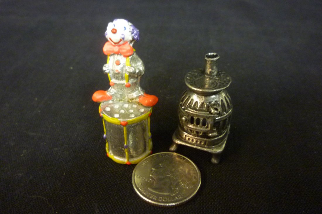 TWO PEWTER THIMBLES WITH POT BELLY STOVE AND CLOWN.: TWO PEWTER THIMBLES WITH POT BELLY STOVE AND CLOWN.