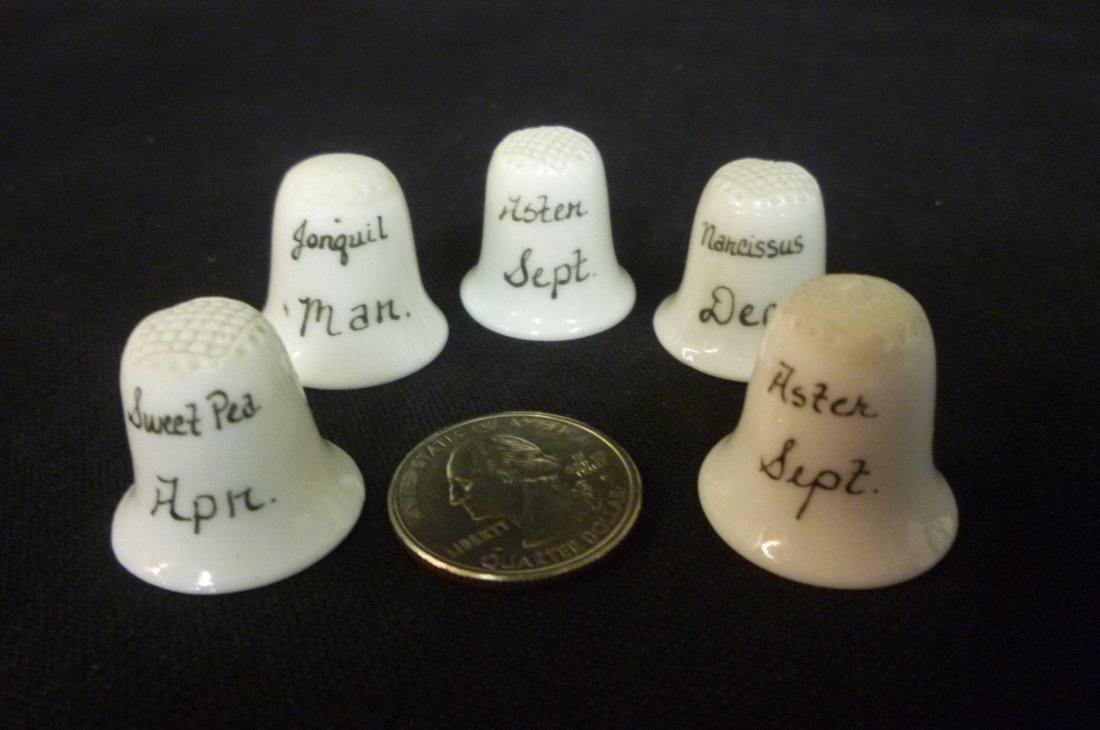 FIVE COLLECTIBLE THIMBLES WITH MONTHS OF THE YEAR.