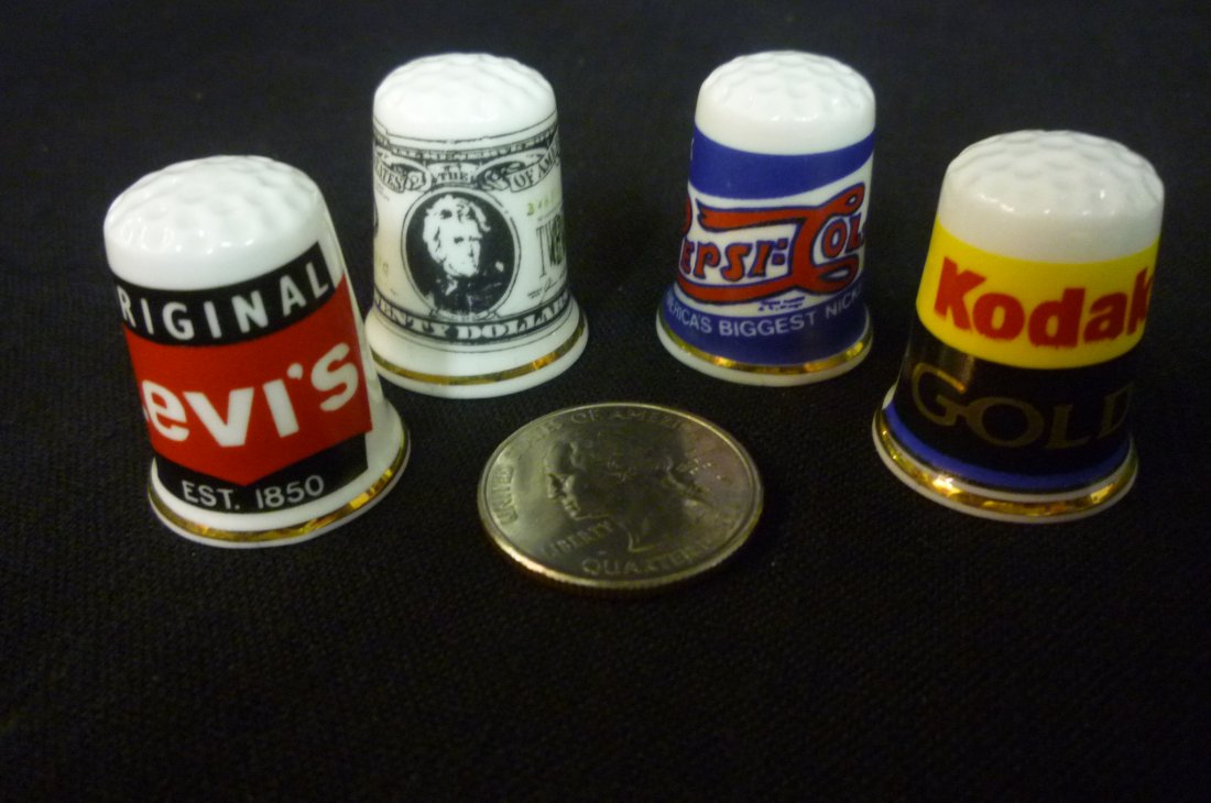 FOUR COLLECTIBLE THIMBLES WITH ADVERTISEMENTS.: FOUR COLLECTIBLE THIMBLES WITH ADVERTISEMENTS.