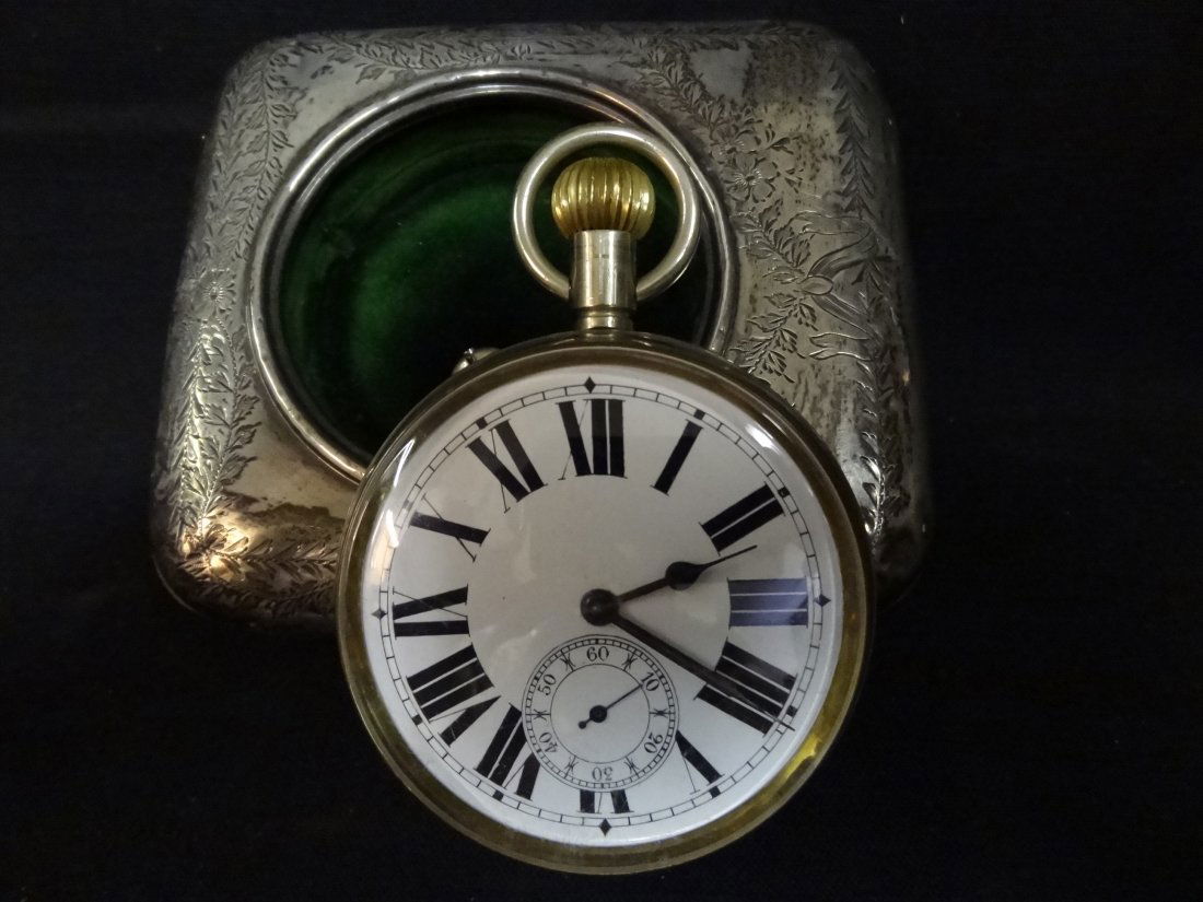 VINTAGE POCKET WATCH SOLID NICKEL WITH ENAMEL FACE.: VINTAGE SOLID NICKEL POCKET WATCH WITH ENAMEL FACE. MARKED SOLID NICKEL, SWISS MADE 48440. 2 1/2'' X 3 1/2''. INCLUDES STERLING SILVER CARRY CASE. THE STAND IS MISSING.