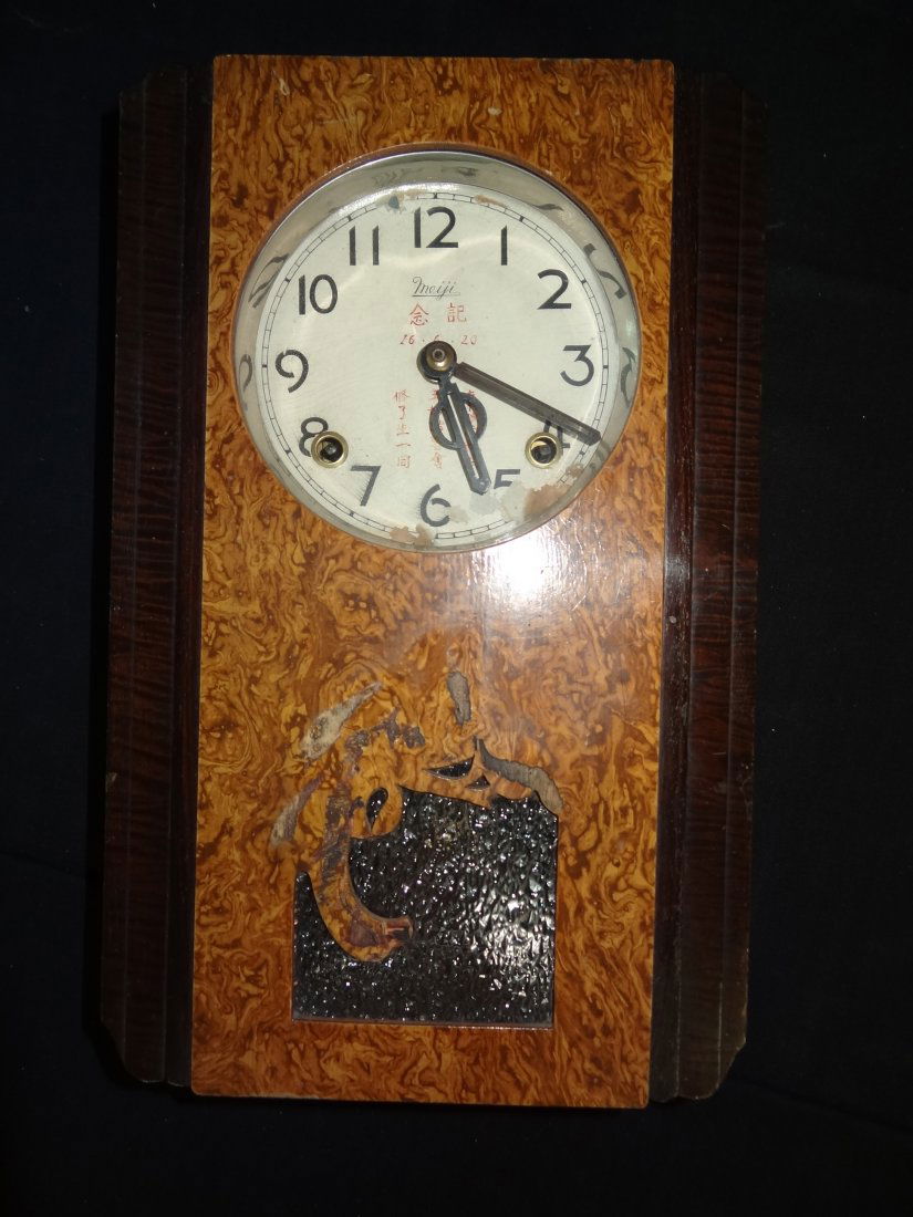 ART DECO MEIJI WALL CLOCK WITH BURL WOOD. GOOD: ART DECO MEIJI WALL CLOCK WITH BURL WOOD. GOOD CONDITION WITH SOME WEAR ON FACE. 9'' X 14 1/2''. WEIGHS 6 LBS.