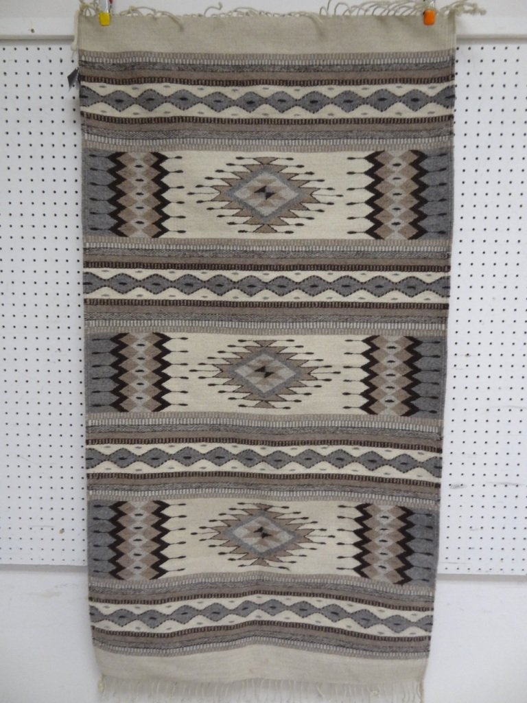 AZTEC ART ARTE DE MANOS MEXICANAS, MEXICAN ARTISAN RUG : AZTEC ART ARTE DE MANOS MEXICANAS, MEXICAN ARTISAN RUG 40'' X 60'' PLUS 3'' KNOTTED FRINGE, BROWN AND GRAY HUES, PATTERN IS TAPETE, PAPER LABEL IS ATTACHED WITH COLOR CODE AND PATTERN NAME.