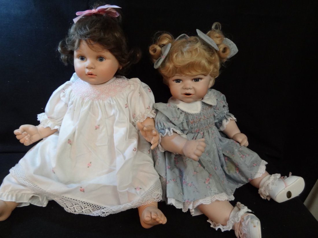 TWO BABY DOLLS, BISQUE HEAD AND LIMBS, SOFT BODY, FIRST: TWO BABY DOLLS, BISQUE HEAD AND LIMBS, SOFT BODY, FIRST DOLL SEYMOUR MANN 296/1200, 16'' TALL IN A SITTING POSITION, BLONDE HAIR BLUE GLASS EYES, EYELASHES, OPEN MOUTH SMILE, CUTE DRESS WITH MATCHING 